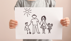 Child in foster care drawing a family