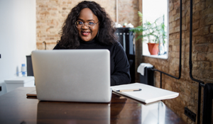 younger caseworker using a laptop