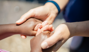 social worker holding a child's hand