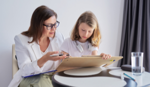 A social worker working with a child 