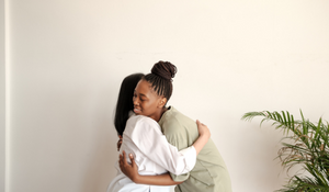 Social worker hugging a client 