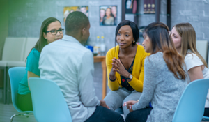 Social worker leading a student peer group