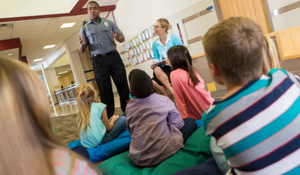 Police officer speaking with a group of students