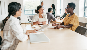 Social services workers using human services software in a meeting 